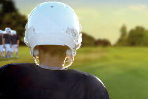 Young athlete in helmet, from behind